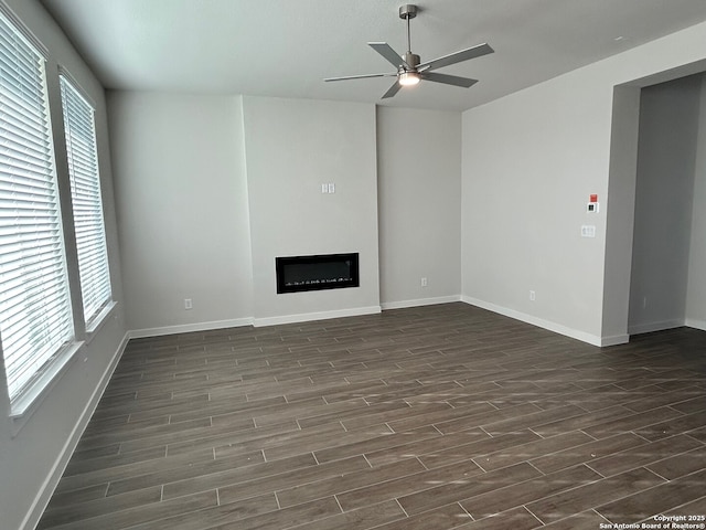 unfurnished living room with ceiling fan