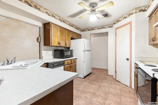 kitchen with ceiling fan, sink, white appliances, and a textured ceiling