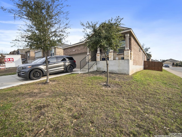 view of front of property featuring a garage, fence, driveway, stone siding, and a front lawn