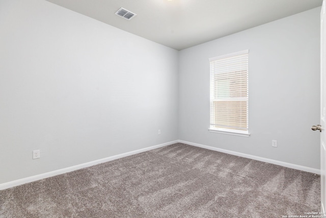 carpeted empty room with baseboards and visible vents