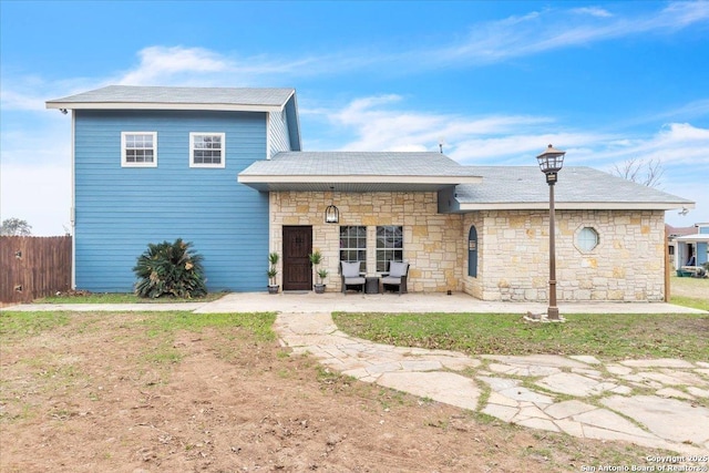 back of house featuring a patio area and a lawn