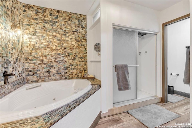 bathroom with separate shower and tub and hardwood / wood-style floors