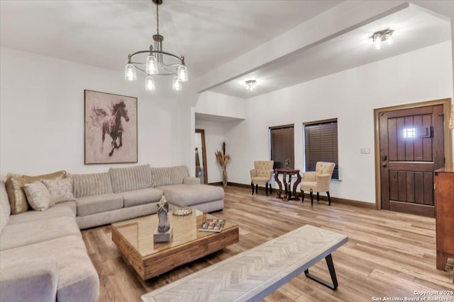 living room featuring an inviting chandelier and hardwood / wood-style flooring