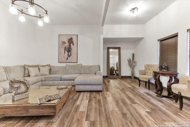 living room featuring a chandelier and wood-type flooring