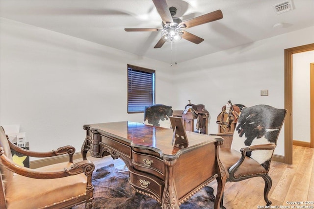 office area with light hardwood / wood-style floors and ceiling fan