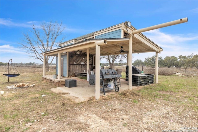 view of patio / terrace featuring a rural view and ceiling fan