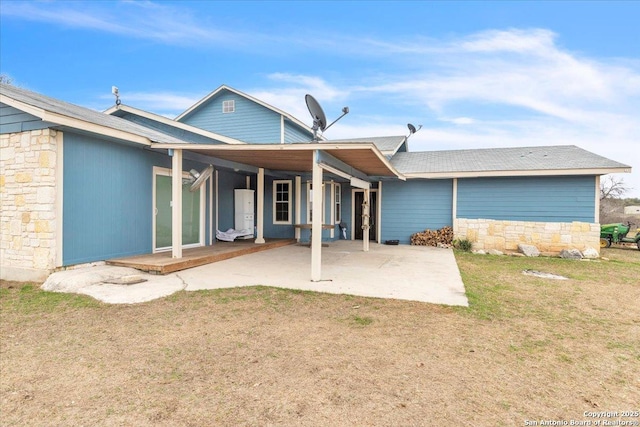 back of property with a patio and a lawn