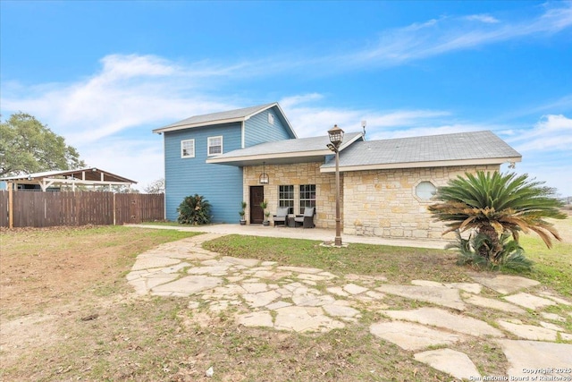 rear view of property featuring a patio area