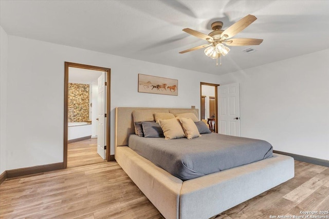 bedroom with ceiling fan, light wood-type flooring, and connected bathroom