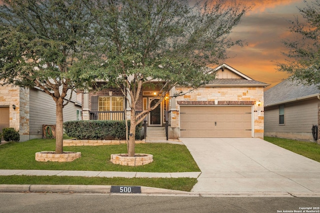 view of front of property with a garage and a lawn