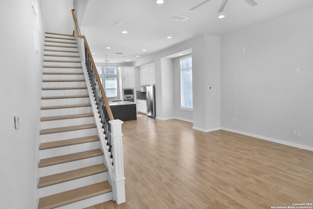 stairway with visible vents, baseboards, a ceiling fan, recessed lighting, and wood finished floors