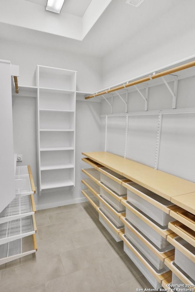 spacious closet featuring tile patterned floors