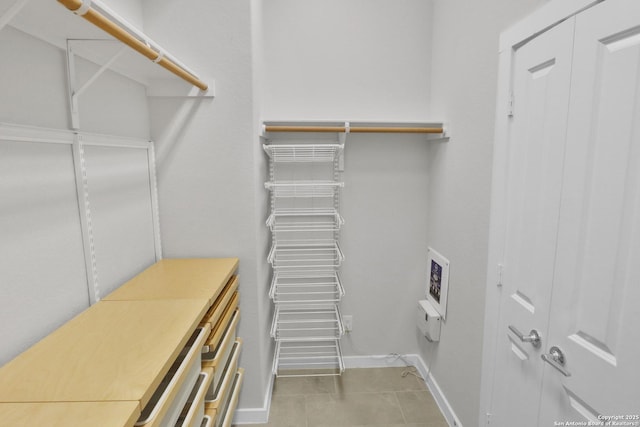 spacious closet featuring light tile patterned floors
