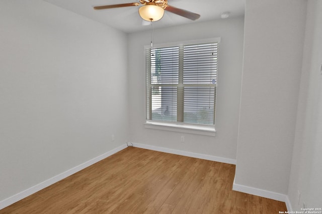 unfurnished room with light wood-type flooring, baseboards, and a ceiling fan