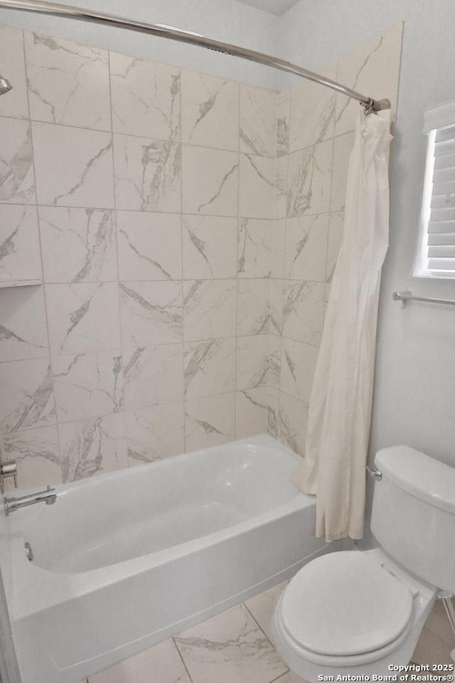 full bathroom featuring toilet, shower / tub combo with curtain, and marble finish floor