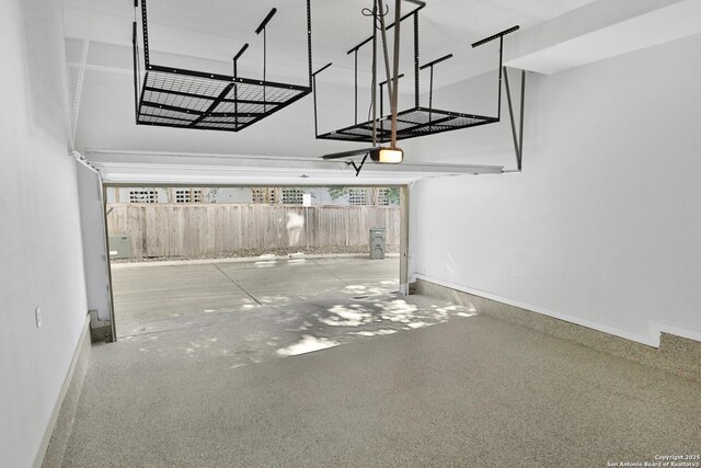 garage featuring baseboards and a garage door opener