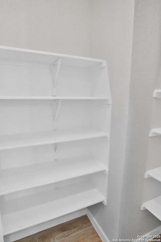 details featuring baseboards and wood finished floors