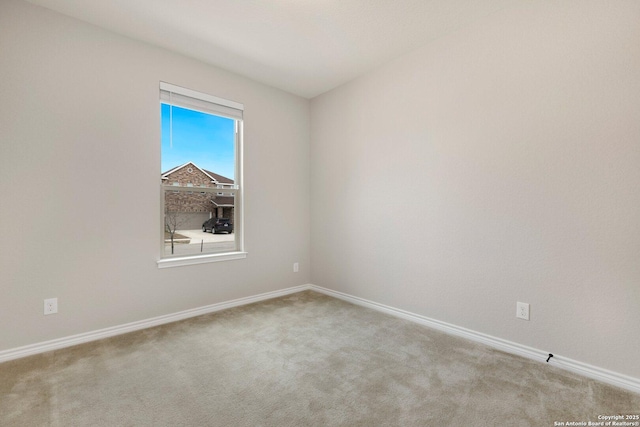 unfurnished room with carpet floors and baseboards