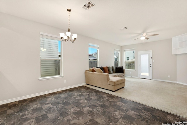 unfurnished living room featuring visible vents, baseboards, and ceiling fan with notable chandelier