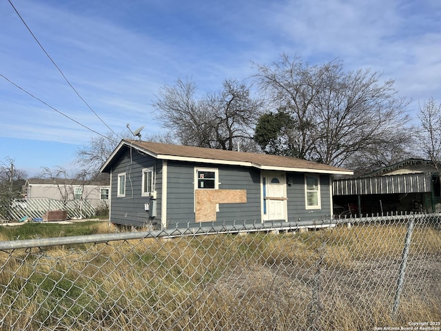 bungalow-style house with fence