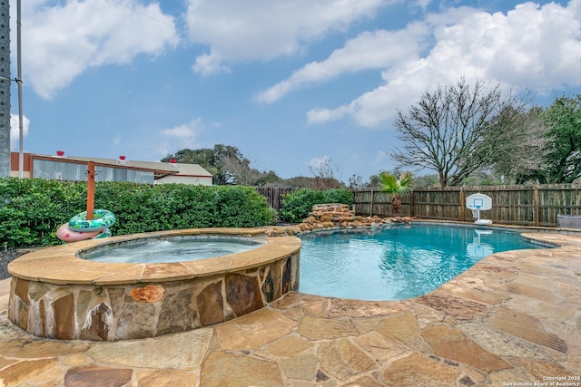 view of pool with a patio area and an in ground hot tub