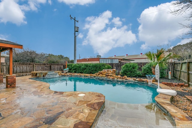 view of swimming pool featuring an in ground hot tub and a patio