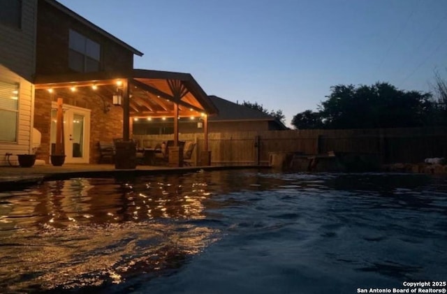 view of pool at dusk