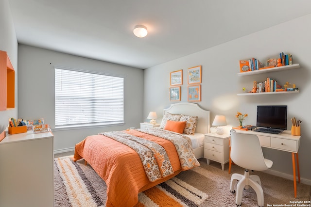 bedroom featuring carpet and baseboards