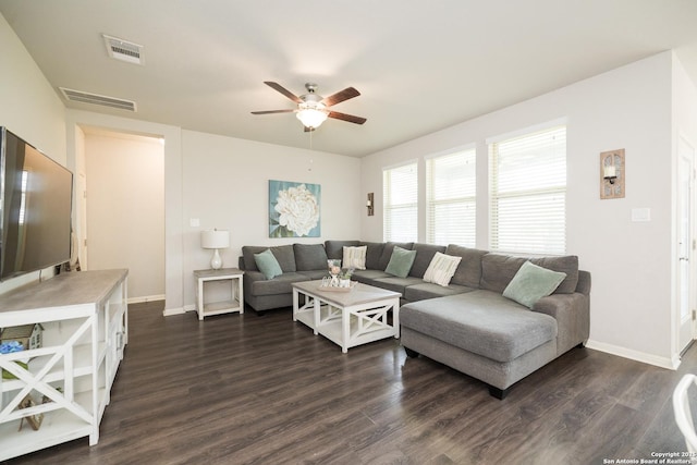 living room featuring ceiling fan and dark hardwood / wood-style floors