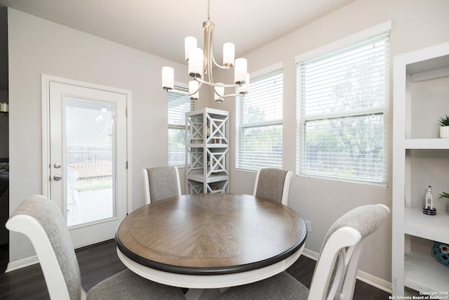 dining space featuring a notable chandelier and dark hardwood / wood-style floors