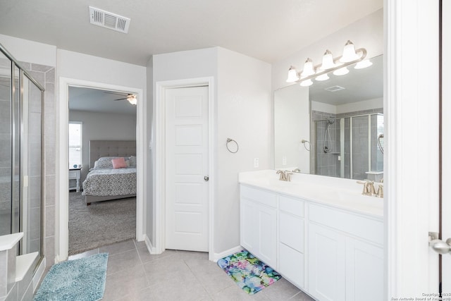 bathroom with ceiling fan, tile patterned flooring, vanity, and walk in shower