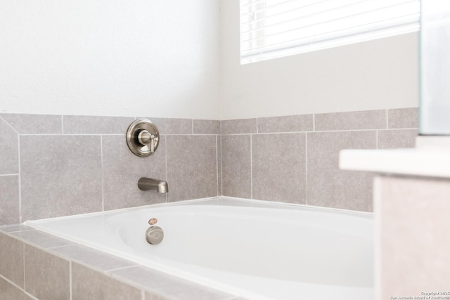 bathroom featuring a relaxing tiled tub