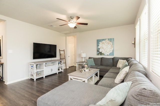 living room with ceiling fan and dark wood-type flooring