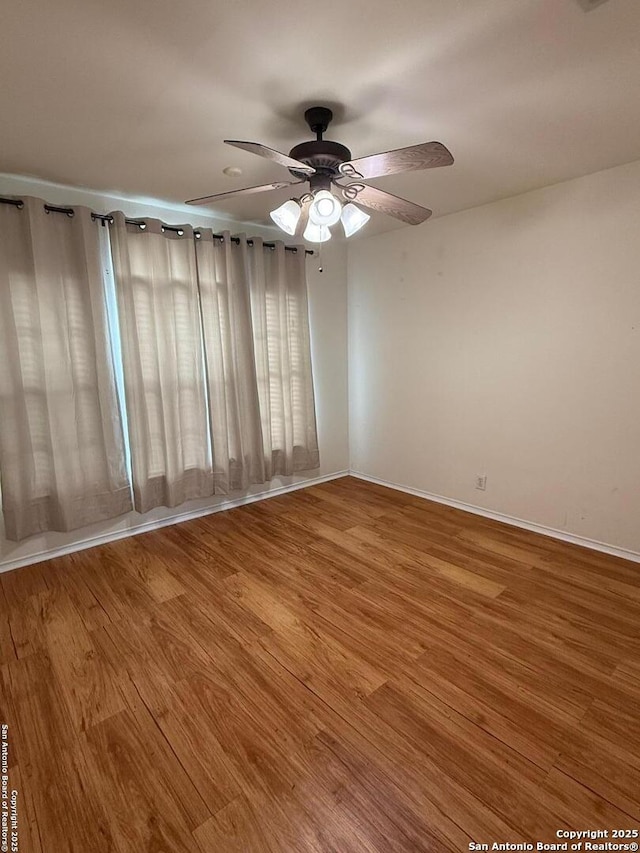 unfurnished room featuring ceiling fan and wood-type flooring