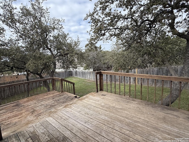 wooden terrace with a lawn