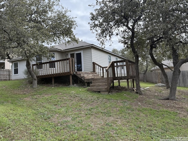 view of front of home featuring a deck and a front lawn