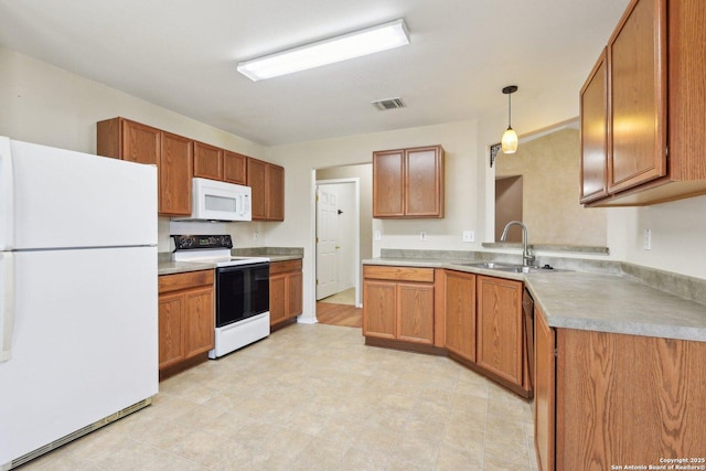 kitchen with white appliances, visible vents, light countertops, brown cabinetry, and decorative light fixtures