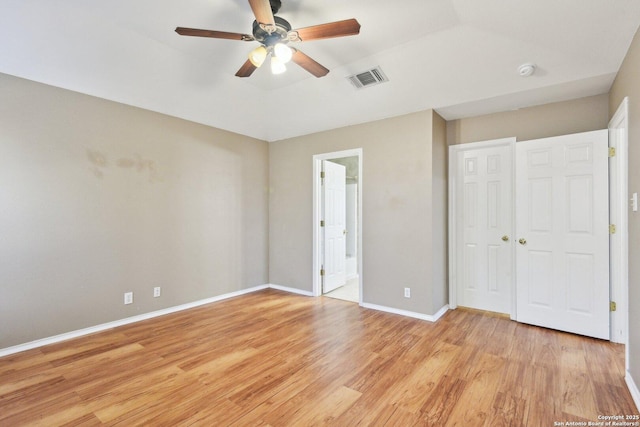 unfurnished bedroom with light wood-type flooring, baseboards, visible vents, and a ceiling fan