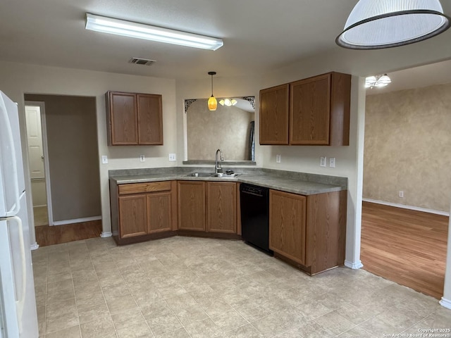 kitchen featuring sink, decorative light fixtures, and dishwasher