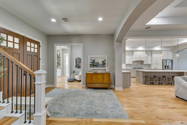 entrance foyer with sink and light hardwood / wood-style flooring