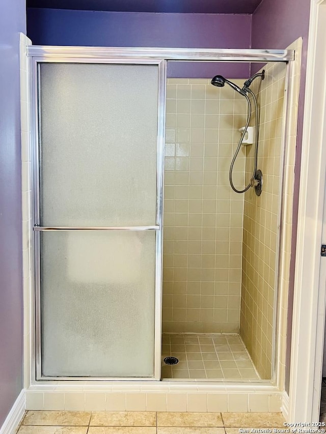 bathroom featuring a shower with door