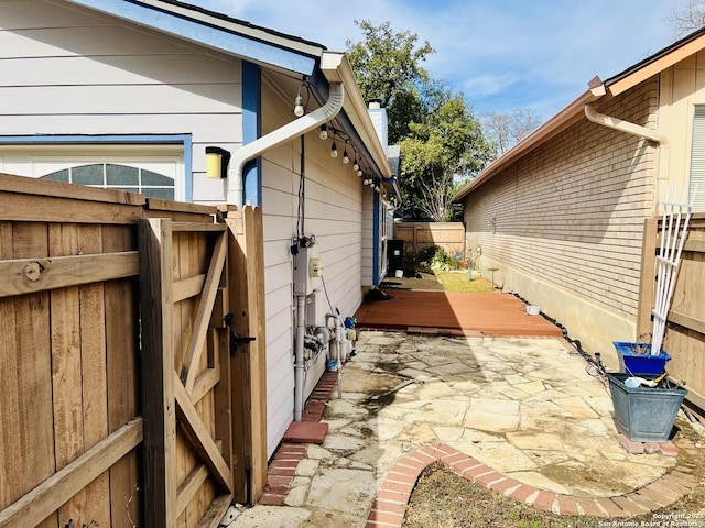 view of property exterior featuring a deck and a patio