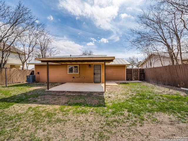 back of property featuring central AC unit, a patio, and a lawn