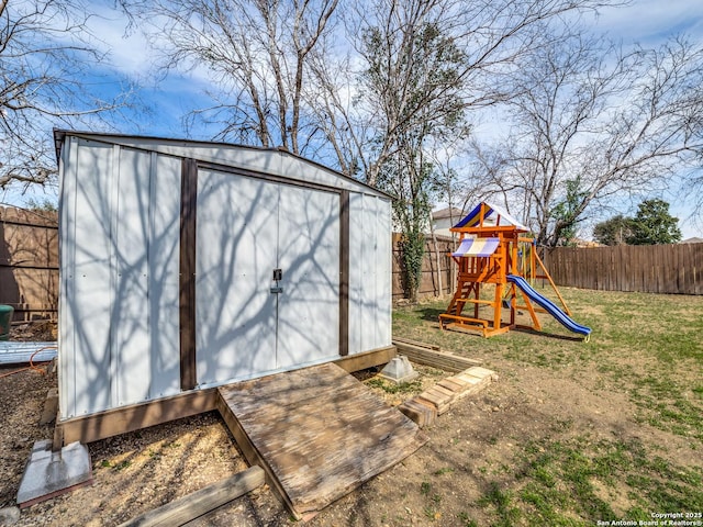 view of outbuilding with a playground and a lawn