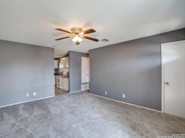 empty room with a textured ceiling, carpet flooring, and ceiling fan