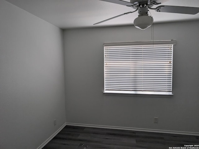 spare room with dark hardwood / wood-style floors and ceiling fan