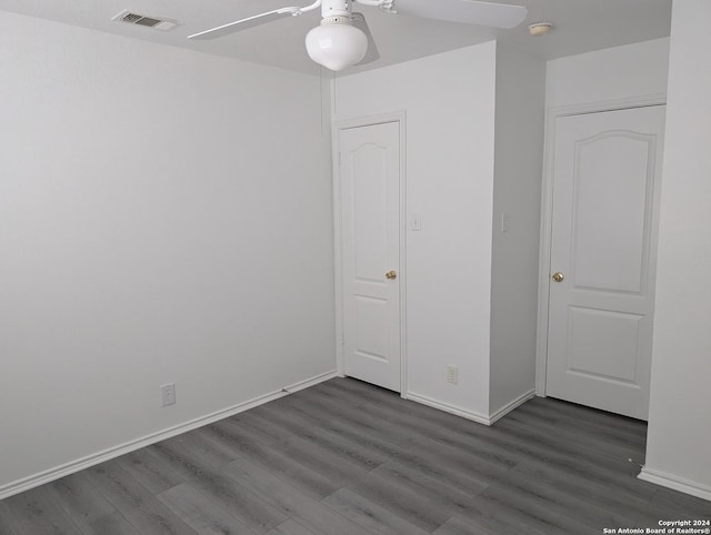 unfurnished bedroom featuring ceiling fan and dark wood-type flooring