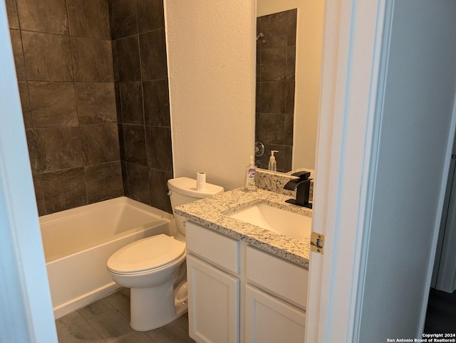 full bathroom featuring tiled shower / bath combo, vanity, toilet, and hardwood / wood-style floors