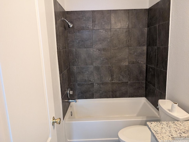 full bathroom with tiled shower / bath combo, vanity, and toilet