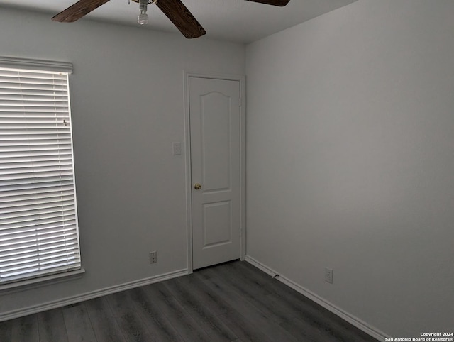 spare room with ceiling fan and dark hardwood / wood-style flooring